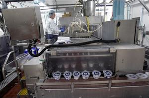 A worker monitors production of Chobani Greek Yogurt in South Edmeston, N.Y.