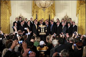 President Barack Obama holds up a Boston Bruins hockey jersey during a ceremony where he honored the 2010-2011 Stanley Cup champion Boston Bruins hockey team.