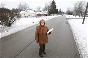 Karen Krause, Democratic chairman of West Toledo's Ward 3, pauses at Jackman and Northover roads. Jackman is one of the dividing lines between the new 9th and 5th Congressional Districts.