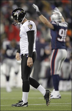 Baltimore Ravens kicker Billy Cundiff (7) walks off the field as New England Patriots outside linebacker Niko Koutouvides (90) celebrates after Cundiff missed a 32 yard field goal in the closing seconds of the AFC Championship NFL football game Sunday.