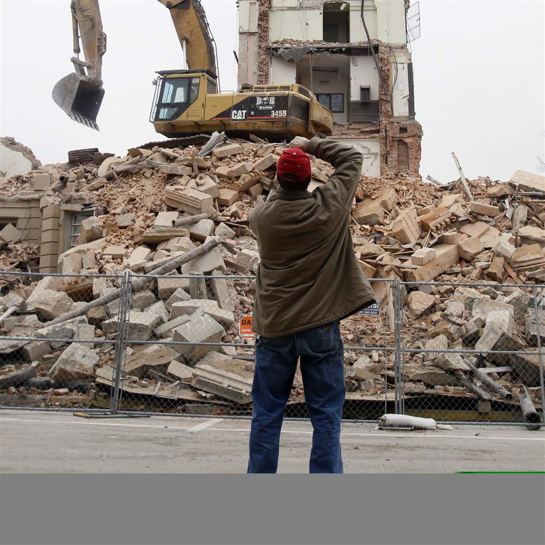 man-observes-demolition