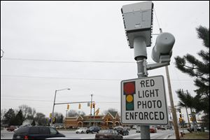 A Red-Light camera on the southbound corner of Secor and Monroe Streets.
