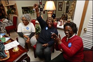From left, Phyllis Wallace, Ann Smith and Beatrice Gracie applaud as they listen in the home of Barbara and Eddie Rome in Toledo, Ohio on Tuesday, to President Barack Obama's State of the Union address.