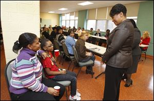 Ohio Supreme Court Justice Yvette McGee Brown talks to Tiffany Simmons, left, and her daughter Treazure Jett, 10, during a visit to the YWCA in downtown Toledo. Justice Brown, an advocate for children and families in her professional and community work, spoke Tuesday to residents of the Y’s housing program.