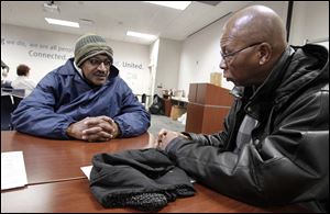 Clive Nicholson of Toledo, left, who is homeless, talks with John Whitlow at the United Way building Wednesday as part of the annual count of the area's homeless population mandated by HUD.