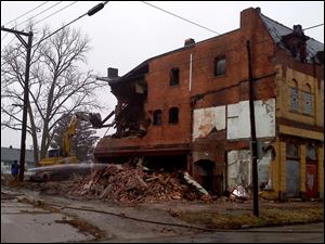 Crews on Thursday begin to demolish the Playdium building in East Toledo.