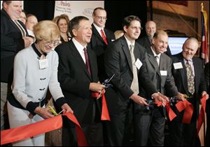 From left: Lucy Marshall, Gov. John Kasich, Chris Marshall and Paul Toth,  at the BX Solutions (former BAX Global) hub facility at Toledo Express during the ribbon-cutting event.