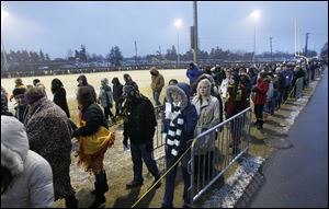 A long line of people wait to enter the Al Glick Field House at the University of Michigan in Ann Arbor, to hear a speech by President Barack Obama, Friday.  He talked about education and requiring universities to keep tuition costs down.