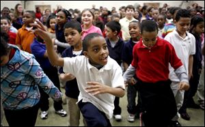 Second-grader Kenyon Boatman dances with classmates during a ‘Get Active, Get Fit Challenge’ at Imagine Madison Avenue School of Arts in Toledo. Anthem Blue Cross and Blue Shield and Radio Disney presented the program Friday at the school and 19 others in Ohio that pledged to do several hours of exercise the last few months. 