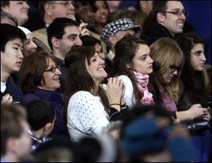 Students listen to President Barack Obama speak at the Al Glick Field House at the University of Michigan in Ann Arbor, Friday.  He talked about education and requiring universities to keep tuition costs down.