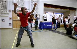 Third-grader D.J. Emanuel Mitchell works a Hula Hoop. Anthem and Radio Disney have been putting on similar programs for three years to encourage healthy lifestyles for children.