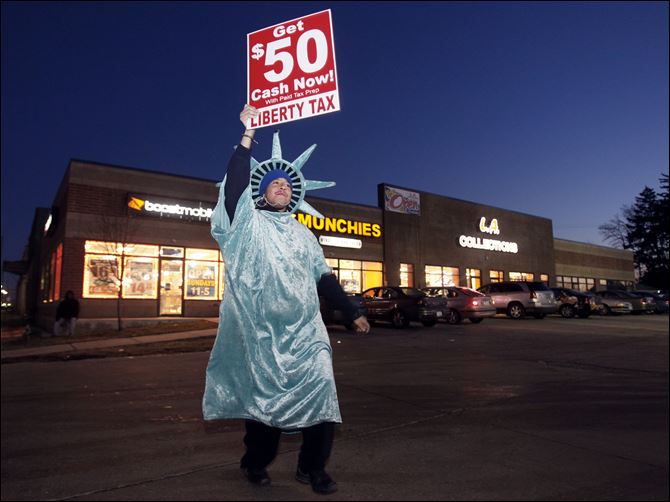 Isaac Underwood, the Statue of Liberty mascot at Liberty Tax Service,  helped thwart robbers by chasing them out of the store and throwing his 20-ounce pop at them Friday, in Toledo, Ohio.