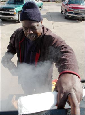 Rick Johnson, 55, cooks chicken for victims of the tornadoes that hit Alabama recently in a church parking lot Friday in Cordova, Ala. Johnson is among the survivors of last year's April tornado outbreak who are pitching in to assist communities that were struck by the most recent onslaught. 