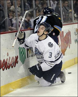 Scott Wietecha of Chicago goes down after battling for the puck with the Walleye’s Bryan Rufenach in the first period Friday night before 6,108 fans at the Huntington Center. After starting the season with three losses against Chicago, Toledo has now beaten it six straight times.
