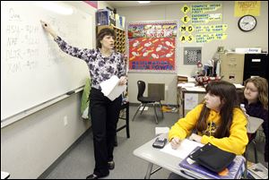 Karen Schrock discusses the contest with her 6th-grade students at Perrysburg Junior High School. She says her students are learning math skills as well as life skills by learning to invest. 'This is like a no-lose, no-win situation,' she says. 'They can learn by investing but not really lose any money.'