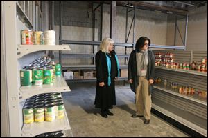 Gretchen S. Carroll, left, Owens’ dean of business, and Krista Kiessling, director of service learning, visit the food pantry at the Perrysburg Township campus. The college also has established a pantry on its Findlay campus.