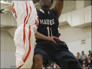 Maumee Valley's Julius Turner, right, takes a shot against Gibsonburg's Gage Beaber on Tuesday. Turner had 18 points, including three 3-pointers in a 75-53 Toledo Area Athletic Conference matchup between the league's top two teams.