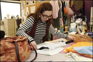 Bianca Marcia, assistant costume designer in the college's theater department, works on transforming a pillowcase into a dress that will be sent to Haiti.