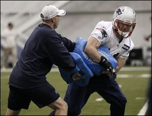 The Patriots' Julian Edelman runs a drill during practice in Indianapolis. The former Kent State QB plays offense, defense, and special teams.