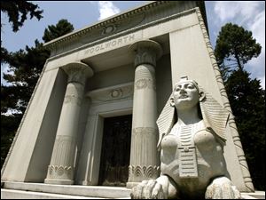 A sphinx stands outside the Woolworth Mausoleum at the Woodlawn Cemetery in the Bronx, where burial can cost more than $1 million. 