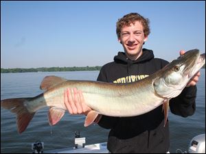 A beaming Jake Lederer shows off his 42-inch muskie took last summer after a 20-minute test of his skills at Alum Creek Reservoir.