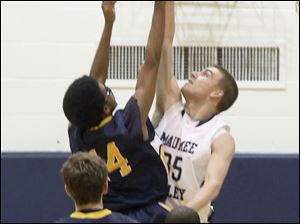 Maumee Valley's #35, Jared Sturt, blocks the shot of Toledo Christian's #14, Damon St. John.
