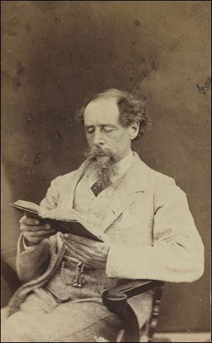 Charles Dickens, shown in 1863, remains best known perhaps for ‘A Christmas Carol.’ A manuscript signed in December, 1843, is in the Morgan Library in New York. The author ‘invented the cliffhanger,’ one scholar says.