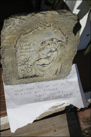 A memorial plaque was left on the porch of the Greenwood Avenue home of Jeffrey Fitzpatrick.