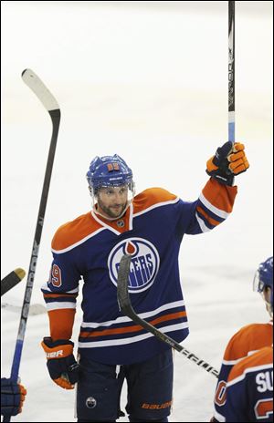 Edmonton Oilers' Sam Gagner salutes the fans after scoring four goals and totalling 8 points against the Chicago Blackhawks during NHL hockey action in Edmonton on Thursday.