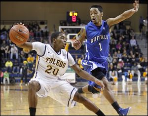 University of Toledo player Julius Brown, 20, stops his drive as Buffalo Bulls player Tony Watson, 1, defends during the second half at Savage Arena.