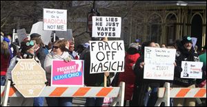 Protesters rally Tuesday outside of Wells Academy/Steubenville High School as Ohio. Gov. John Kasich highlights the themes of education and shale gas drilling in his State of the State address.