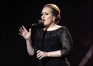 Adele performs on stage during the Brit Awards 2011.