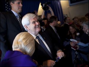 Republican presidential candidate and former House Speaker Newt Gingrich talks with voters Tuesday during a campaign stop at the Price Hill Chili Restaurant in Cincinnati.