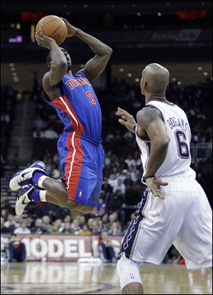 Detroit Pistons' Ben Gordon (8) shoots against New Jersey Nets' Keith Bogans (6) during the second quarter Wednesday night.