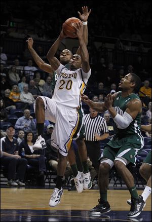 Toledo's Julius Brown, who had 14 points, drives the basket against Ohio's D.J. Cooper. The Rockets dug out of a 15-0 hole to improve their record to 11-13 overall, 3-7 in the Mid-American Conference.