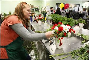 Alyssa Bianco works on an arrangement at Bartz Viviano on Secor Road. Valentine’s Day is the busiest holiday of the year for the florist.