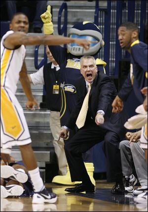 Toledo men’s coach Tod Kowalczyk, right, says balance in life outside of coaching is a key to keeping healthy.