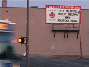 A billboard near North Erie Street and Washington Avenue downtown expresses Toledo firefighters union Local 92's displeasure with the city.