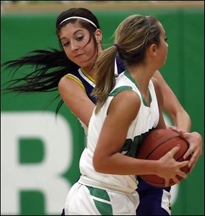 Archbold's Darian Oberlin, back, battles Delta's Bri Raab for the ball Thursday night at Delta High School. The Panthers had a shot at tying the Blue Streaks for a league title but fell short.