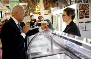 Vice President Joe Biden buys ice cream from Jeni Britton Bauer, founder of Jeni's Splendid Ice Creams, during his visit to Columbus' North Market Thursday. It was his second visit to Columbus this year.