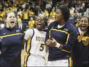 Toledo's Anna Capotosto, left, Janelle Reed-Lewis, Brianna Jones, and Mariah Carson after the Rockets beat the Falcons 52-50. 