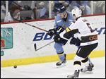  Walleye defender Riley Emmerson and Cyclones No. 5 Chris Clark battle for the puck as Toledo hosts Cincinnati at Huntington Center on Feb. 12. The Walleye beat the Cyclones 3-2 in overtime.