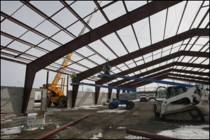 Ed Schmidt's car dealership has a 23,000 square foot body shop under construction at the firm's location in Perrysburg.