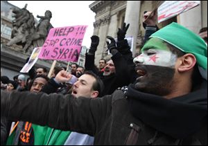 People chant slogans during an anti-Syrian regime protest in downtown Brussels, Sunday, Feb. 12, 2012. 