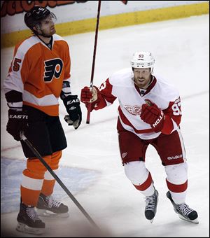 Detroit Red Wings right wing Johan Franzen (93), of Sweden, celebrates his goal against Philadelphia Flyers goalie Sergei Bobrovsky in the third period of an NHL hockey game in Detroit, Sunday, Feb. 12, 2012. Detroit won 4-3. Detroit equaled an NHL record with its 20th straight win at home, beating Philadelphia 4-3. 