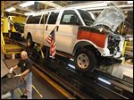  A General Motors employee works on a van assembly line at GM's plant in Wentzville, Mo.