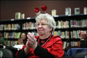As the balls on her headband wobble, Joyce Barteck, 74, applauds the children's musical number. Mrs. Barteck is one of the grandfriends in the program with Whittier Elementary School children.