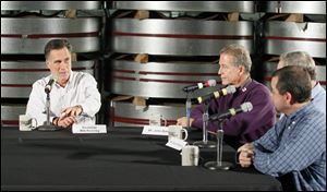 Mitt Romney conducts a roundtable at National Galvanizing as owner John Bates, next to Mr. Romney, listens.