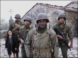 Matteo Sciabordi, Omar Benson Miller, Michael Ealy, Derek Luke and Laz Alonso are shown in a scene from "Miracle at St. Anna," the story of four black American soldiers stationed in Tuscany, Italy during Word War II.