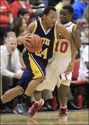 LeRoy Alexander, who led Whitmer with 18 points, drives against Central Catholic's Dexter Johnson. The Panthers improved to 17-2.